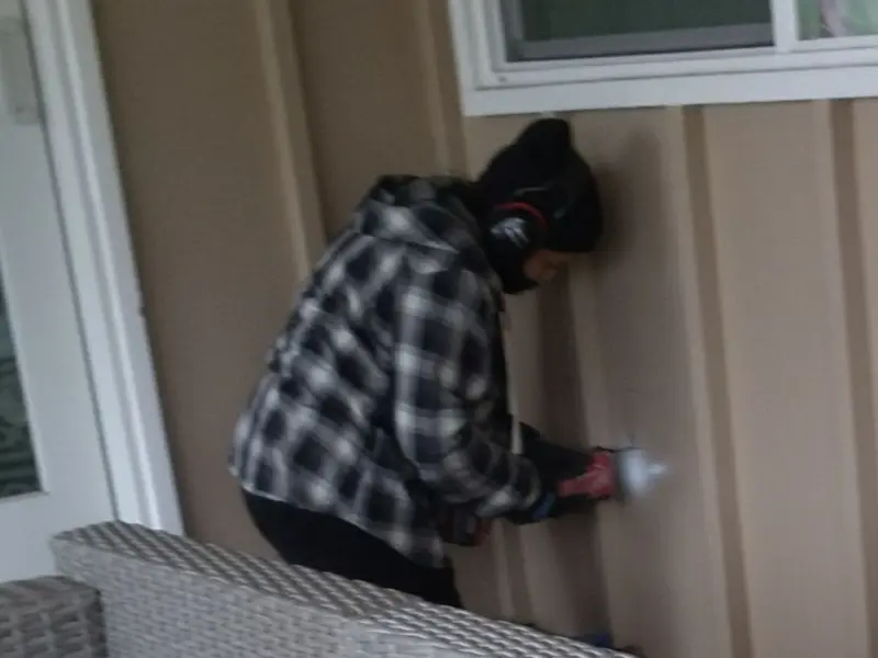 Professional electrician installing an exterior outlet in Ellsworth