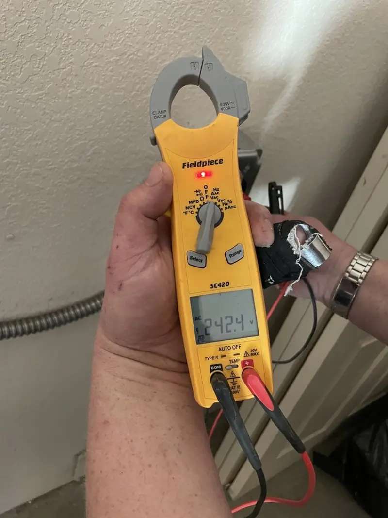 Voltage testing with clamp meter during Whole House Surge Protector in Ellsworth